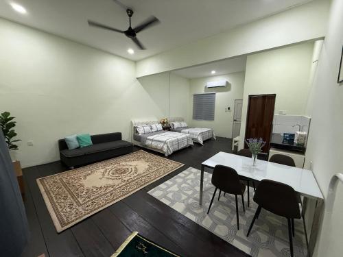 a living room with a couch and a table at cozy nest panji in Kota Bharu