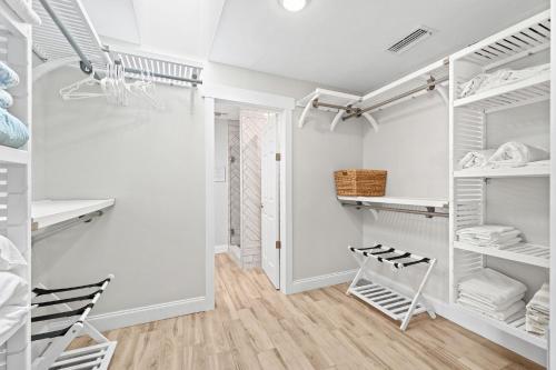 a walk in closet with white shelving at 445 Watts Way in Cocoa Beach