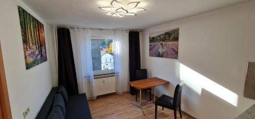 a living room with a couch and a table and a window at 2 Room Flat near Uni Campus Siegen - BR in Siegen