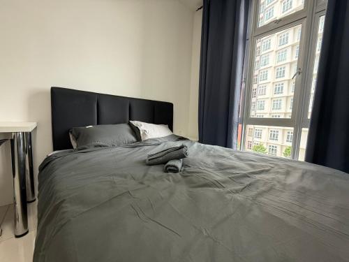 a large bed in a bedroom with a large window at Suite For 5pax The Anderson Residence Ipoh #57 in Ipoh
