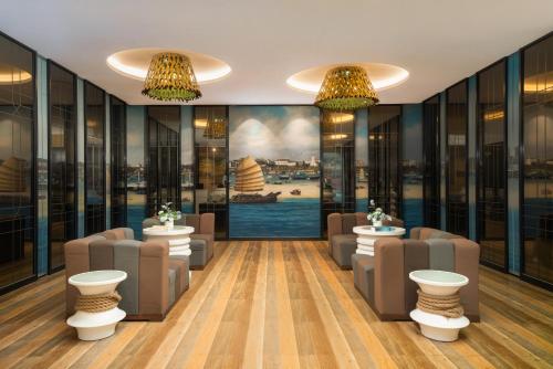a waiting room with chairs and a painting of a ship at LN Hotel Five-Canton Fair Free Shuttle Bus & Free Snack in Guangzhou