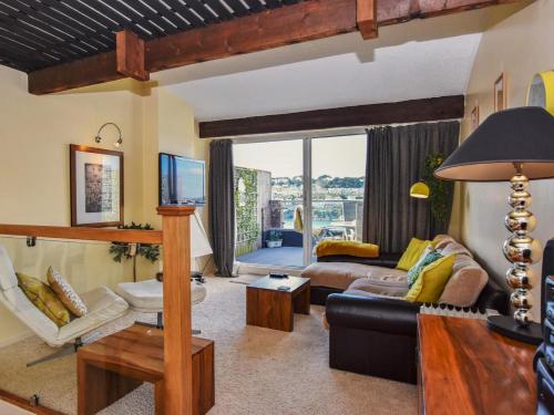 a living room with a couch and a table at 2 Bed in Polruan 75740 in Polruan