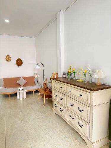 a living room with a dresser and a couch at Nap House 2- house in center Phan Thiet in Ấp Bình Hưng