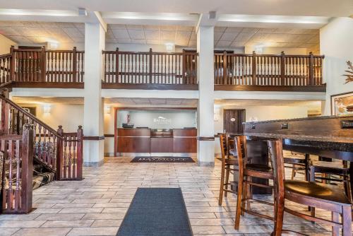 a large lobby with a bar and a stage at Baymont by Wyndham Bloomington MSP Airport in Richfield