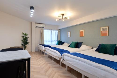 a row of beds in a room at 梅田から1駅 - Umeda 1stop, Shin-Osaka 10m, 2m to Sta, 2F - XS41 in Osaka
