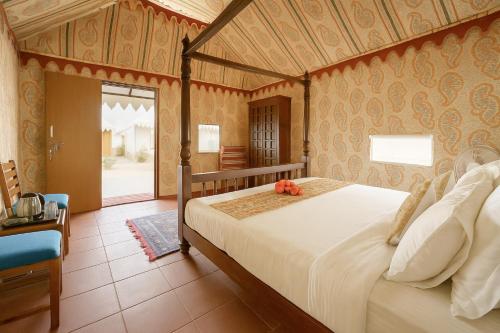 a bedroom with a large bed in a room at The Saffron Desert Camp, Jaisalmer in Jaisalmer