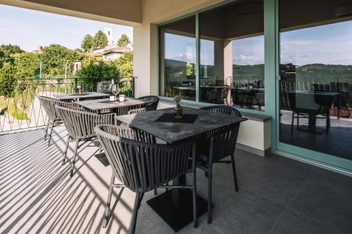 a patio with tables and chairs on a balcony at Villa Sofija in Kojsko