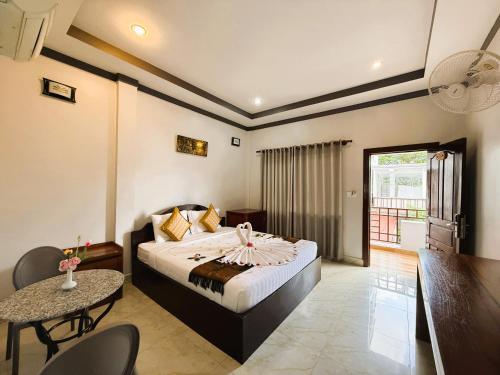 a hotel room with a bed and a table and a tablektop at Golden Bakong Boutique in Siem Reap