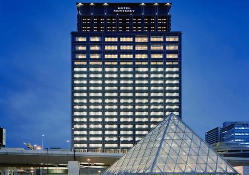 a tall building with a pyramid in front of it at Hotel Monterey Grasmere Osaka in Osaka