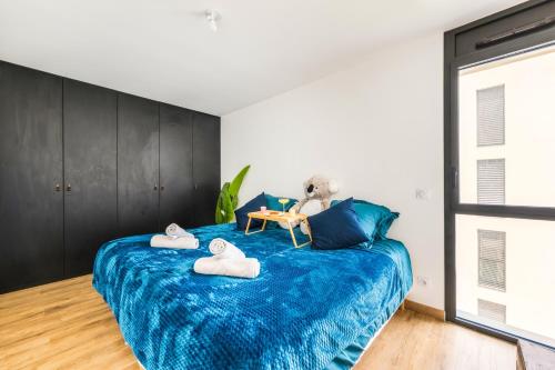 a bedroom with a blue bed with a teddy bear on it at BnGo I Luxury & Prestige I Garage, Terrace, in Lyon