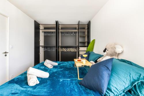 a bedroom with a large bed with blue sheets at BnGo I Luxury & Prestige I Garage, Terrace, in Lyon