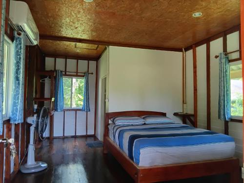 a bedroom with a bed in a room at Cha Bungalow in Ko Yao Noi