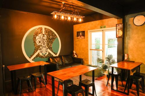 a restaurant with tables and a couch in a room at Crashpalace Backpackers in Rotorua