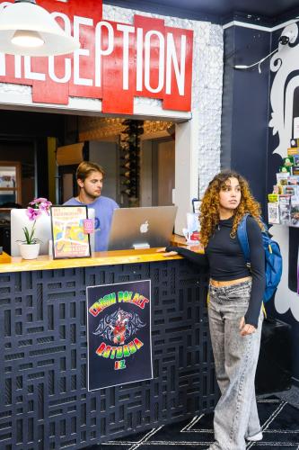 a woman standing in front of a restaurant at Crashpalace Backpackers in Rotorua
