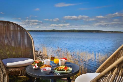 a table with food on it next to a body of water at Krägga Herrgård in Bålsta