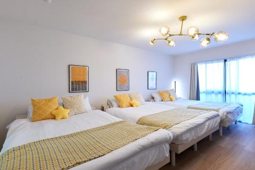 two beds in a room with white walls at 新大阪10分 - 1stop Umeda, Shin-Osaka 10m, USJ 30m, MAX6 - XS46 in Osaka