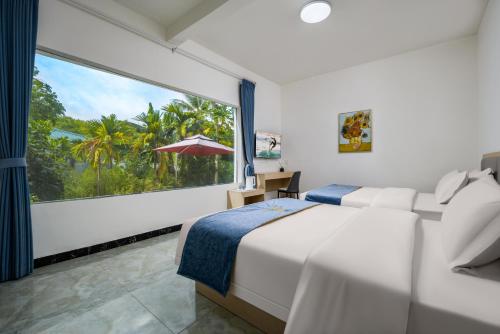 a bedroom with a bed and a large window at Haishu Yuntian 