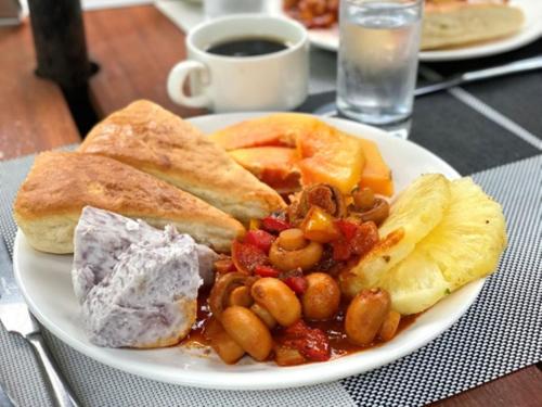 a plate of food with beans and bread on a table at Central Beautiful & peaceful Private bedroom AC, Very fast WiFi 1 in Dar es Salaam