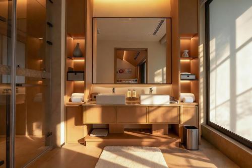 a bathroom with a sink and a mirror at Chengdu Expo Waterfall Hotel - MGallery Collection in Chengdu