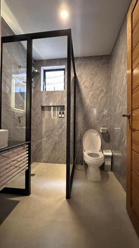 a bathroom with a toilet and a sink and a shower at ThePureYann in San Juan