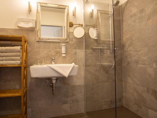 a bathroom with a sink and a shower at Hasseröder Burghotel in Wernigerode