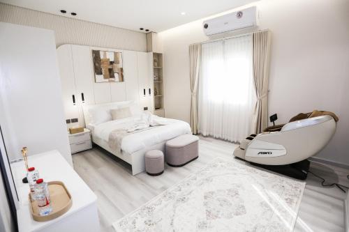 a white bedroom with a bed and a white sink at paradise resort and spa in Hatta