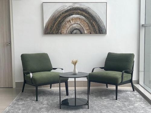 two chairs and a table in a room at UTD8 Hotel and Residence in Bangkok