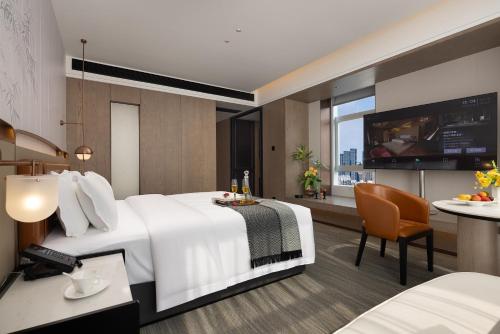 Ένα ή περισσότερα κρεβάτια σε δωμάτιο στο 长沙温德姆花园酒店-世界之窗芒果馆店