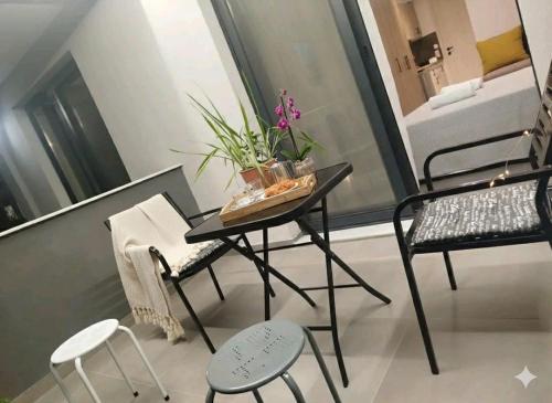 a small table and chairs in a small room at Elegant Dream Suites in Ayia anna