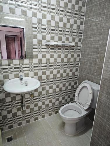 a bathroom with a toilet and a sink at Million Mansion in Bangkok