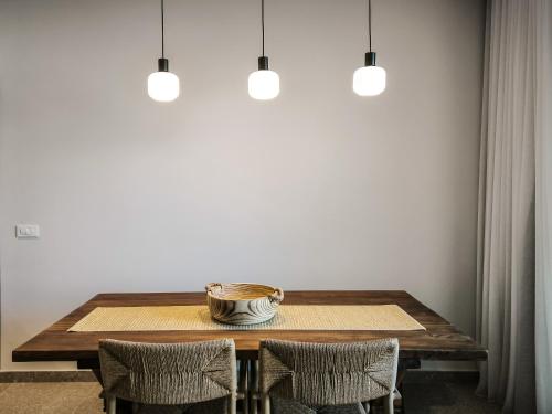 a dining room table with two chairs and a bowl on it at AnNiko Suites Nafplio in Katsíngrion