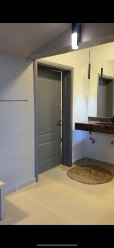 an empty room with a door and a rug at Luna in Jāḩis