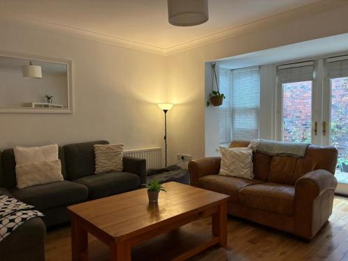 a living room with two couches and a coffee table at Durham City Centre 5 bedroom House in Gilesgate