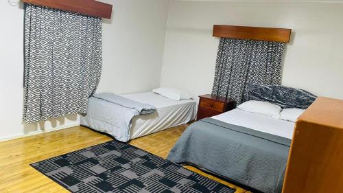 Ένα ή περισσότερα κρεβάτια σε δωμάτιο στο Beachfront 4BR BnB with Pool at Laucala Beach