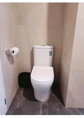 a bathroom with a white toilet in a stall at Long Bay Breeze Ensuite in Auckland