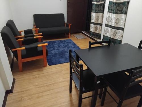 a living room with a black table and chairs at Toorak Suva 2BR City Center Minutes Away in Suva