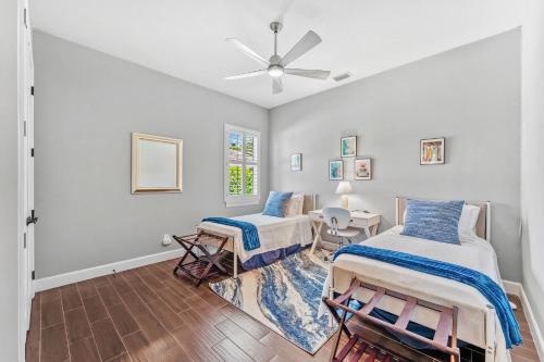 Un dormitorio con dos camas y un ventilador de techo. en 131 Seminole Ln, en Cocoa Beach