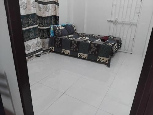 a room with a couch sitting on a white floor at Toorak Suva 2BR City Center Minutes Away in Suva