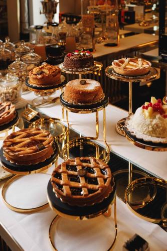 una serie di torte e altri dolci su un tavolo di Bra Hotel a Bari