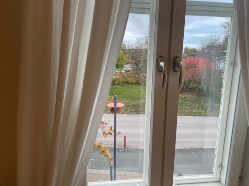 a window with a view of a street at Entire 4 rooms Cozy apartment in central Älmhult in Älmhult