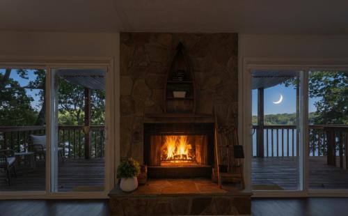 a fireplace in a living room with a fire place at Lakefront Escape with Sauna Hot Tub BBQ & Games in Norris Lake Shores