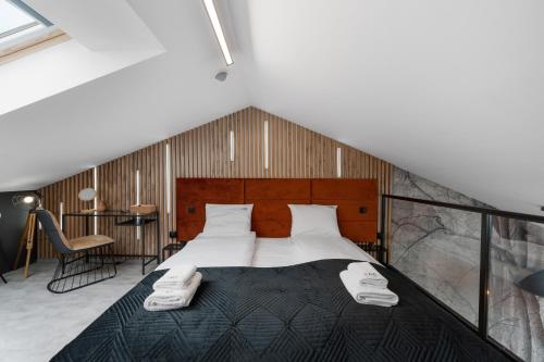 a bedroom with a large bed with white sheets at Calm Sauna & Jacuzzi by OneApartments in Sopot