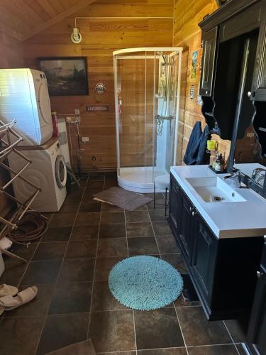 une salle de bain avec une douche, un lavabo et une baignoire dans l'établissement Trollvang, hytte med pool og sauna, à Dovreskogen