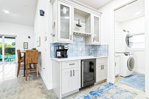 a kitchen with white cabinets and a table and chairs at 409 Washington Ave in Cape Canaveral