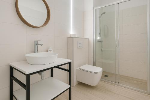 a bathroom with a sink and a toilet and a mirror at JoValiMarAnt in Mikołajki