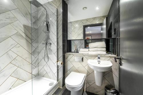 a bathroom with a toilet sink and a shower at EPIC Duke Street Townhouse, City Centre Apartments in Liverpool