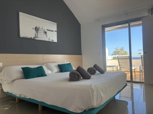 a bedroom with a large bed with towels on it at Relax Blue Marlin Pasito Blanco in Pasito Blanco