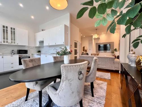 a kitchen and dining room with a table and chairs at Spacious Family Apartment for 9 near Brussels Midi Station in Brussels