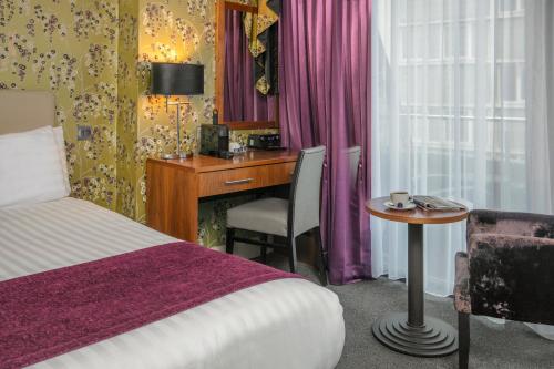 a hotel room with a bed and a desk at Fenwick Street Hotel by EPIC in Liverpool