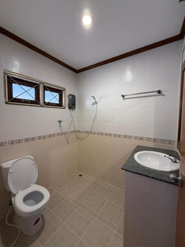 a bathroom with a toilet and a sink at Mr. Black Resort in Haad Rin
